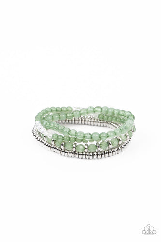 A mismatched collection of opaque and crystal-like Basil beads intermix with silver accents and white crystal-like beads along stretchy bands around the wrist, creating colorful layers.