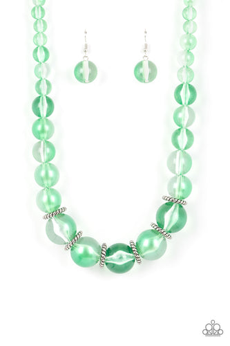 Lightly brushed in a pearly green shimmer, glassy translucent beads gradually increase in size as they are threaded along an invisible wire below the collar. Textured silver rings separate the largest beads, adding grounding accents to the opalescent display. Features an adjustable clasp closure. 