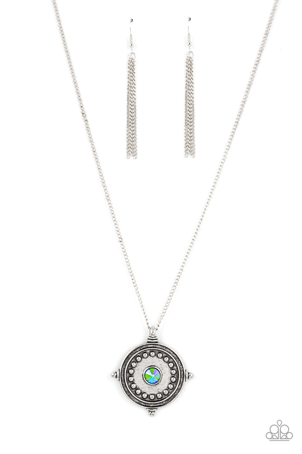 An iridescent green rhinestone is pressed into the studded center of a compass inspired frame, creating a stellar pendant at the bottom of an extended silver chain. Due to its prismatic palette, color may vary. Features an adjustable clasp closure. 