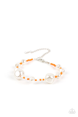 Irregular-shaped pearls in varying sizes are scattered amongst orange and white seed beads that are threaded along a wire, resulting in a refreshing and playful style around the wrist. Features an adjustable clasp closure. 