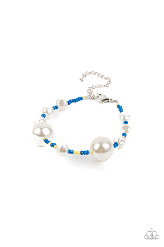 Irregular-shaped pearls in varying sizes are scattered amongst blue and yellow seed beads that are threaded along a wire, resulting in a refreshing and playful style around the wrist. Features an adjustable clasp closure. 