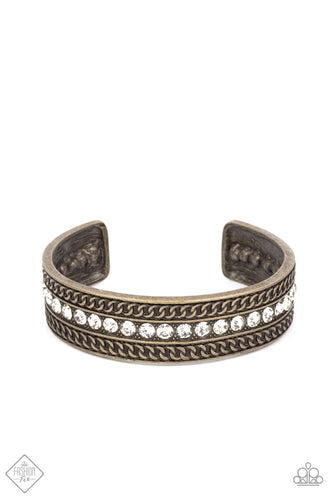 A row of sparkling white rhinestones, surrounded by studded texture, is bordered by an intricate chain-like motif etched in antiqued brass. The contrast of sparkle and grit results in an unapologetically industrial cuff that wraps boldly around the wrist.  Sold as one individual bracelet.  New Kit Fashion Fix