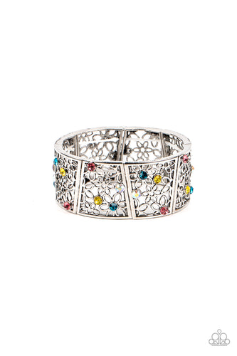 Sporadically dotted with multicolored and iridescent rhinestones, an airy daisy pattern blooms inside trapezoidal silver frames that are threaded along stretchy bands around the wrist for a seasonal statement. Due to its prismatic palette, color may vary.