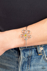 Dotted with a Daffodil rhinestone center, shiny silver bars curve into a floral frame atop a dainty silver bangle around the wrist. Features a pronged closure.