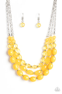 Separated by dainty silver rings, mismatched rows of glassy, opaque, and solid Daffodil acrylic crystal-like beads are threaded along invisible wires below the collar, creating vivacious layers. Features an adjustable clasp closure. Featured inside The Preview at GLOW!