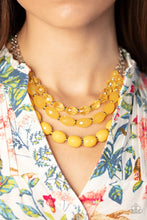 Load image into Gallery viewer, Separated by dainty silver rings, mismatched rows of glassy, opaque, and solid Daffodil acrylic crystal-like beads are threaded along invisible wires below the collar, creating vivacious layers. Features an adjustable clasp closure. Featured inside The Preview at GLOW!
