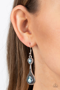 wo iridescent blue rhinestones adorn the top and bottom of an extended silver lure radiating with studded textures, resulting in an ethereal dazzle. Earring attaches to a standard fishhook fitting. Due to its prismatic palette, color may vary. 