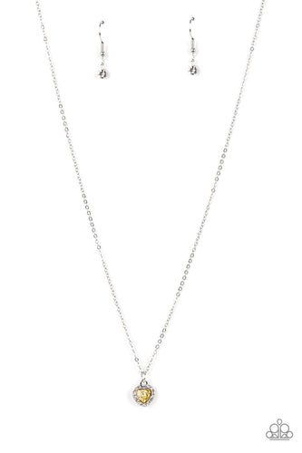 Bordered in glassy white rhinestones, a dainty yellow rhinestone heart sparkles along a dainty silver chain below the collar for a flirtatious fashion. Features an adjustable clasp closure.