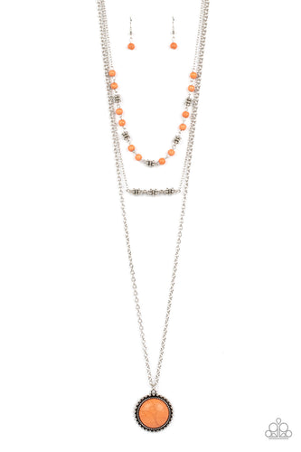  A round orange stone, set in a studded antiqued silver frame, creates a bold pendant at the bottom of a lengthened silver chain. This earthy statement piece is accompanied by layered strands of orange stone beads and antiqued silver accents that connect to dainty silver chains making a charming layered design. Features an adjustable clasp closure.