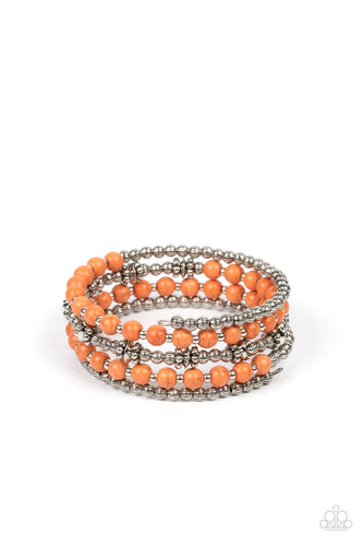 Infused with vibrant orange stone beads, a mismatched assortment of textured silver beads, studded silver rings, and dainty silver accents are threaded along a coiled wire, creating an earthy infinity wrap around the wrist. 