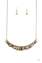 Load image into Gallery viewer, A curved bar of antiqued brass is trimmed with a mashup of glitzy aurum and faceted golden topaz gems that shimmer inside studded brass frames, creating a scintillating sparkle below the collar. Features an adjustable clasp closure. 
