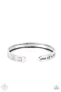 A minimalistic silver bar etched with the words, “one of a kind” on one end and embellished with a dainty rhinestone and pastel gems on the other, curves into a simple cuff around the wrist.  Sold as one individual bracelet.  New Kit Fashion Fix