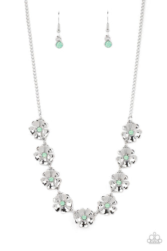 Heart-shaped silver petals bloom from opaque Basil rhinestone centers, creating colorful flowers. The dainty floral frames delicately dance below the collar, connecting into a whimsical centerpiece. Features an adjustable clasp closure. 
