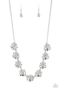 Heart-shaped silver petals bloom from opaque Basil rhinestone centers, creating colorful flowers. The dainty floral frames delicately dance below the collar, connecting into a whimsical centerpiece. Features an adjustable clasp closure. 