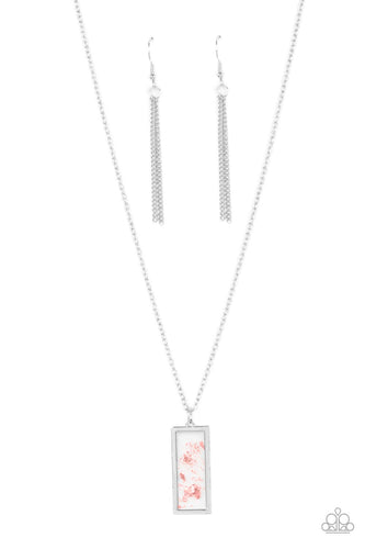 Flecks of iridescent pink shell are encased inside a glassy frame bordered in silver, creating a whimsical pendant below the collar. Features an adjustable clasp closure.
