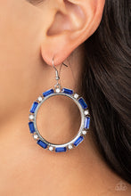 Load image into Gallery viewer, A glittery collection of round white and emerald cut blue rhinestones smolders along the outside rim of a shiny silver hoop, resulting in an edgy centerpiece. Earring attaches to a standard fishhook fitting.
