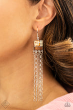 Load image into Gallery viewer, A peachy square-cut rhinestone is paired with two smaller gems in a milky iridescent finish and set above a rectangular bar of natural wood to create an art deco-inspired frame. A stream of vintage silver chains falls from the modern display, bringing playful energy to the artful design. Earring attaches to a standard fishhook fitting.  Sold as one pair of earrings.  New Kit Fashion Fix
