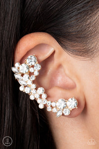 A sparkly collision of round and marquise cut white rhinestones tumble down the ear, coalescing into an out-of-this-world sparkle. Features a clip-on fitting at the top for a secure fit. 