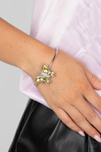 Load image into Gallery viewer, A silver butterfly with yellow teardrop rhinestone wings and a white-rhinestone body delicately perches atop a shiny silver cuff. Featured inside The Preview at GLOW!
