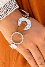 Load image into Gallery viewer, An assortment of silver hoops and discs are hammered in handcrafted texture as they link around the wrist. A strip of brown leather connects two of the pieces, adding a touch of rustic charm to the design. Features an adjustable clasp closure.  Sold as one individual bracelet.  New Kit Fashion Fix
