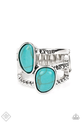 Keep The Piece - Blue. A chiseled piece of turquoise stone swings from a collision of interconnected silver hoops rich in handcrafted texture. A hammered silver disc anchors the swinging pendant at the bottom of a bulky silver chain, completing the artisanal statement piece. Features an adjustable clasp closure. Sold as one individual necklace. Includes one pair of matching earrings. 