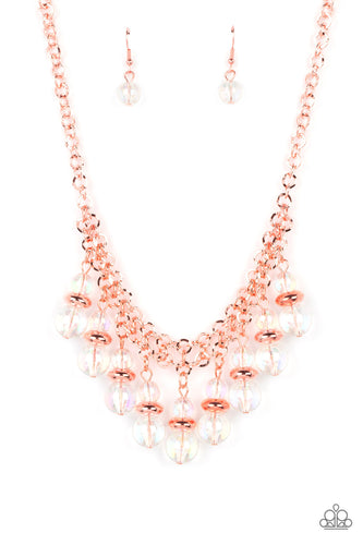 Featuring a stellar iridescence, pairs of glassy beads are separated by shiny copper discs, trickling below the collar in an effervescent fringe. Features an adjustable clasp closure. Due to its prismatic palette, color may vary. 