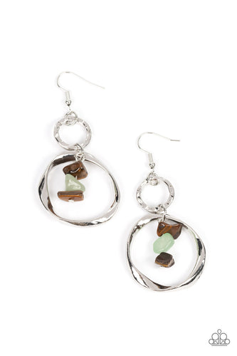 A warped silver hoop links with a hammered silver hoop, interlocking into a rustic lure. Threaded along a metal rod, tiger's eye and jade pebbles trickle from the top of the lowermost hoop for a tranquil finish. Earring attaches to a standard fishhook fitting.