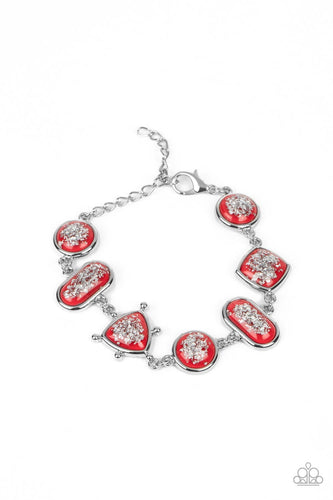 Glassy red beads speckled in flecks of silver shimmer delicately connect around the wrist in a glitzy geometric display. Features an adjustable clasp closure. 