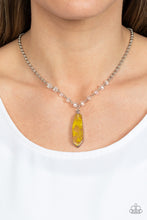 Load image into Gallery viewer, Featuring a faux stone finish, yellow smoke is encapsulated in an acrylic frame below the collar. Glittery crystal-like beads sparkle along the silver chain, drawing attention to the mystical pendant. Features an adjustable clasp closure. Due to is prismatic palette, color may vary. 
