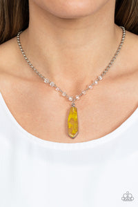 Featuring a faux stone finish, yellow smoke is encapsulated in an acrylic frame below the collar. Glittery crystal-like beads sparkle along the silver chain, drawing attention to the mystical pendant. Features an adjustable clasp closure. Due to is prismatic palette, color may vary. 