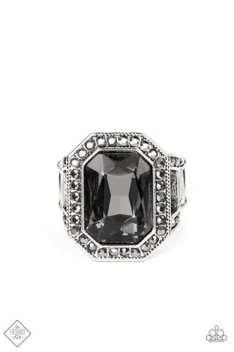 An oversized, smoky, emerald-cut gem smolders inside a framework of studded silver texture and glitzy hematite rhinestones, resulting in an awe-inspiring statement piece that glamorously sits atop the finger. Features a stretchy band for a flexible fit.  Sold as one individual ring.  New Kit Fashion Fix