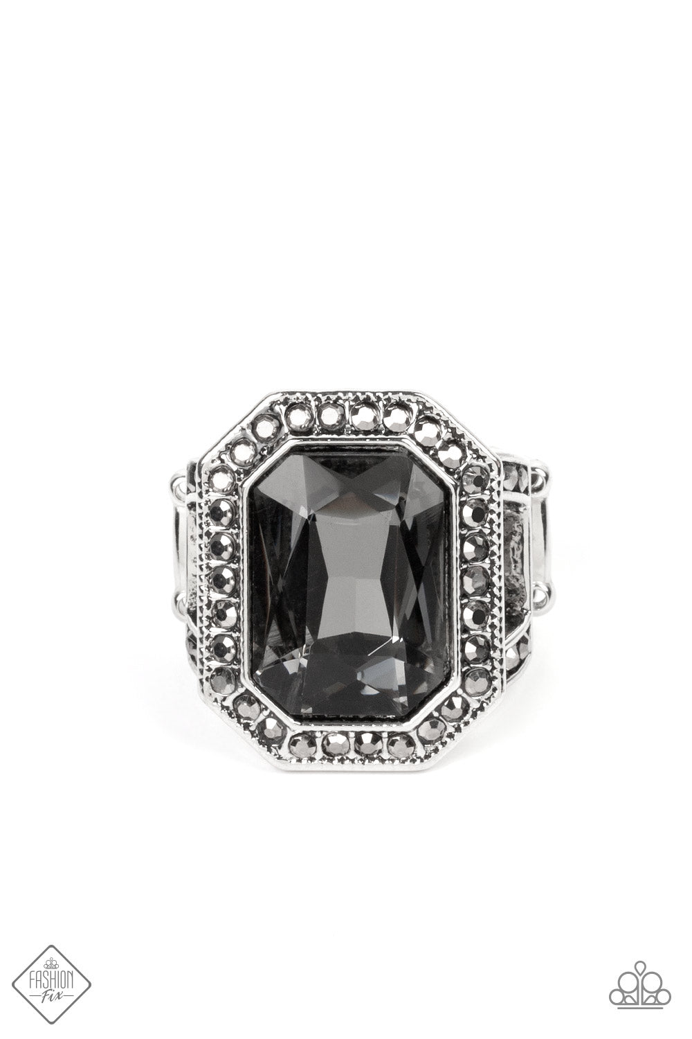 An oversized, smoky, emerald-cut gem smolders inside a framework of studded silver texture and glitzy hematite rhinestones, resulting in an awe-inspiring statement piece that glamorously sits atop the finger. Features a stretchy band for a flexible fit.  Sold as one individual ring.  New Kit Fashion Fix