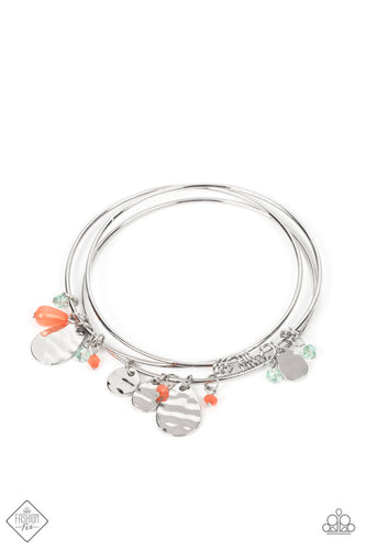 A stack of three silver bangles are adorned with hammered silver discs, tiny coral and Basil beads, and sleek silver links, creating a charming combination.  Sold as one individual bracelet.  New Kit Fashion Fix