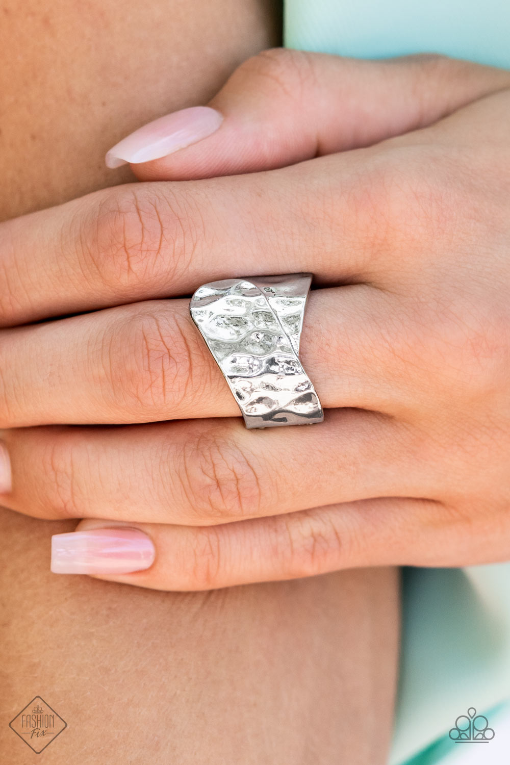 Two wide silver ribbons are hammered in texture as they delicately overlap at the center of the finger to create a rustic metallic statement piece. Features a stretchy band for a flexible fit.  Sold as one individual ring.  New Kit Fashion Fix