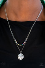 Load image into Gallery viewer, Dotted in a single silver stud, a star-stamped silver disc glistens at the bottom of a classic silver chain. Infused with faceted silver beads, a stellar collection of oil spill crystal-like beads glides along a flat silver chain, resulting in out-of-this-world layers below the collar. Features an adjustable clasp closure.  Sold as one individual necklace. Includes one pair of matching earrings.  New Kit Fashion Fix
