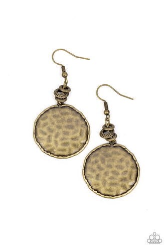 A dainty collection of smooth and hammered brass rings gives way to an antiqued brass disc. Bordered in an asymmetrical brass trim, the hammered disc ripples in the light with each turn and twist. Earring attaches to a standard fishhook fitting.