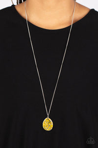 Featuring a shell-like iridescence, shimmery flecks are sprinkled along a mustard yellow backdrop inside of a glassy casing. The colorful teardrop swings from the bottom of an extended silver chain, creating a summery pendant. Features an adjustable clasp closure. </p><br>Featured inside The Preview at GLOW! 