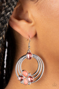 Glassy and opaque coral beads are strategically placed around rings of silver and accented white rhinestones to create a dreamy beach look. Earring attaches to a standard fishhook fitting.