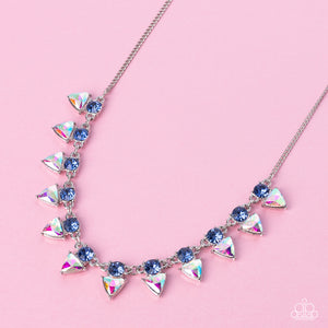 Solitaire blue rhinestones sparkle atop iridescent prism-like gems below the collar, linking into a sharp-looking statement piece. Features an adjustable clasp closure. Due to its prismatic palette, color may vary.