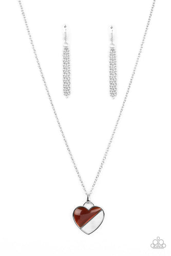 Encased in a silver heart frame, a glassy brown bead and white shell-like stone lay side-by-side, creating a romantic pendant at the bottom of a classic silver chain. Features an adjustable clasp closure.