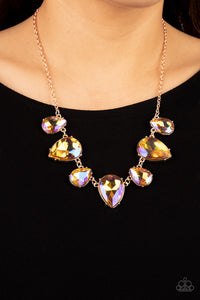 Featuring a stellar iridescence, an oversized collection of glittery iridescent teardrop gems alternates upside down and right-side-up below the collar for an out-of-this-world sparkle. Features an adjustable clasp closure. Due to its prismatic palette, color may vary. 