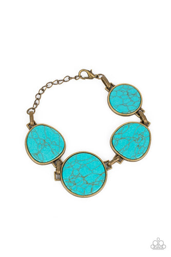 Flat turquoise stones pressed into brass frames provide a statement focal point around the wrist. Features an adjustable clasp closure. As the stone elements in this piece are natural, some color variation is normal.