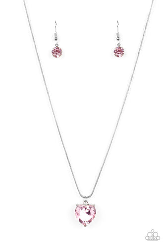 A heart-shaped rhinestone brushed in a pink finish sparkles brilliantly as it slides along a skinny silver snake chain. The gem is pressed into a thick silver frame, allowing its faceted surface to be emphasized. Features an adjustable clasp closure. 