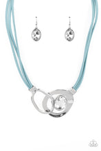 Load image into Gallery viewer, Attached to shimmery strands of blue leather, a pair of oversized and warped silver links delicately overlaps into a contemporary centerpiece below the collar. An exaggerated white gem asymmetrically embellishes the silvery accent piece, adding unexpected elegance to the modern design. Features an adjustable clasp closure. 
