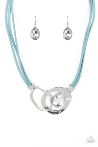 Attached to shimmery strands of blue leather, a pair of oversized and warped silver links delicately overlaps into a contemporary centerpiece below the collar. An exaggerated white gem asymmetrically embellishes the silvery accent piece, adding unexpected elegance to the modern design. Features an adjustable clasp closure. 