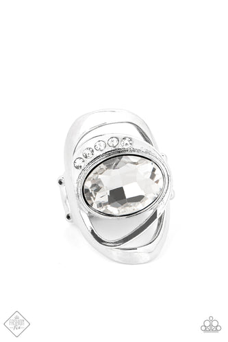 An oversized white oval gem is tilted on its side and nestled into a sleek silver frame. A row of dainty white rhinestones runs along the edge of the faceted centerpiece, as a larger silver frame ripples out from underneath, creating an abstract and modern statement piece. Features a stretchy band for a flexible fit.  Sold as one individual ring.  New Kit Fashion Fix