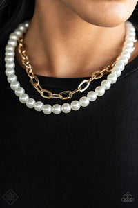 A string of classic white pearls is layered with a strand of oversized gold links, creating a gorgeous collision of refinement and grit as they lay along the collar. Features an adjustable clasp closure.  Sold as one individual necklace. Includes one pair of matching earrings.