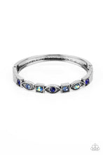 Load image into Gallery viewer, A collection of square and marquise-shaped frames arc across the wrist in a stunning geometric display. Sapphire, light sapphire, and blue iridescent rhinestones are pressed into the centers of the thick silver frames, adding irresistible sparkle to the bangle-inspired design. Features a hinged closure. Due to its prismatic palette, color may vary.
