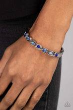 Load image into Gallery viewer, A collection of square and marquise-shaped frames arc across the wrist in a stunning geometric display. Sapphire, light sapphire, and blue iridescent rhinestones are pressed into the centers of the thick silver frames, adding irresistible sparkle to the bangle-inspired design. Features a hinged closure. Due to its prismatic palette, color may vary.
