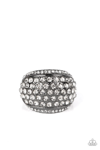 A thick band of gunmetal arcs across the top of the finger, creating an exaggerated rounded frame. Countless tiny white rhinestones scatter across the surface, as straight lines of even more rhinestones line the outer edges in a blinding finish. Features a stretchy band for a flexible fit. 